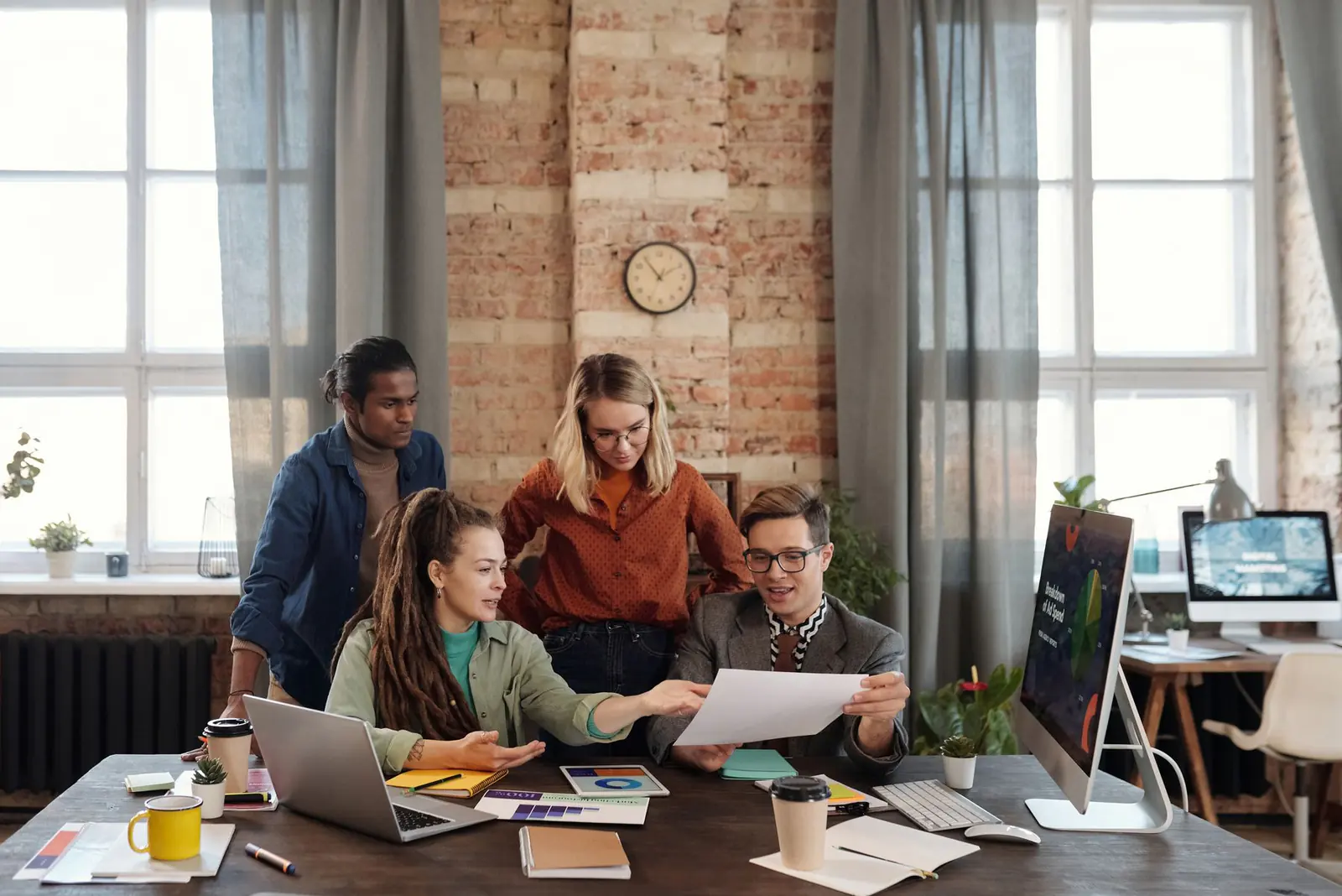 A small business team talking through a plan at a shared table