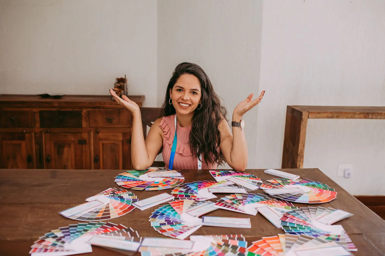 A designer surrounded by colour swatch fans
