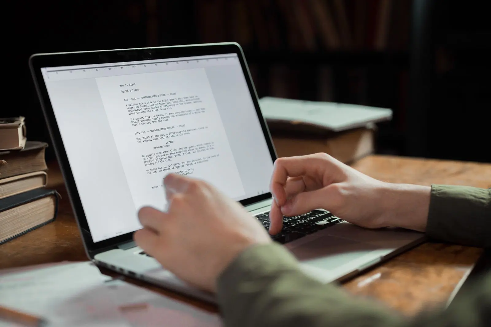 Typing an article into a document on a laptop